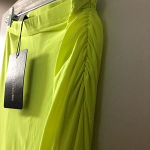 Long fitted asymmetrical neon skirt. Never worn, fits small